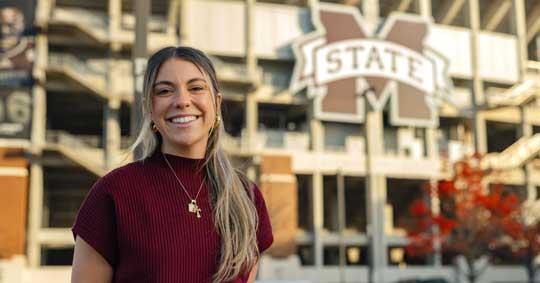 MASOL Student Smiling in front of Davis Wade Stadium
